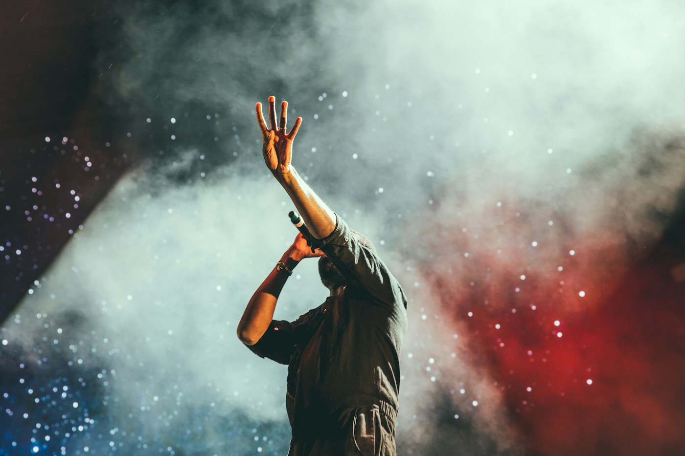 Performer on stage under concert lighting